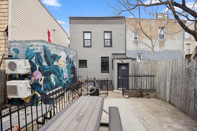 118 Kingsland Ave Unit 1, New York City, NY 11222 - back of house with a cooling unit and a chimney