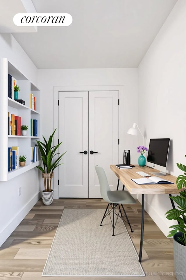 office space featuring baseboards and light wood-type flooring