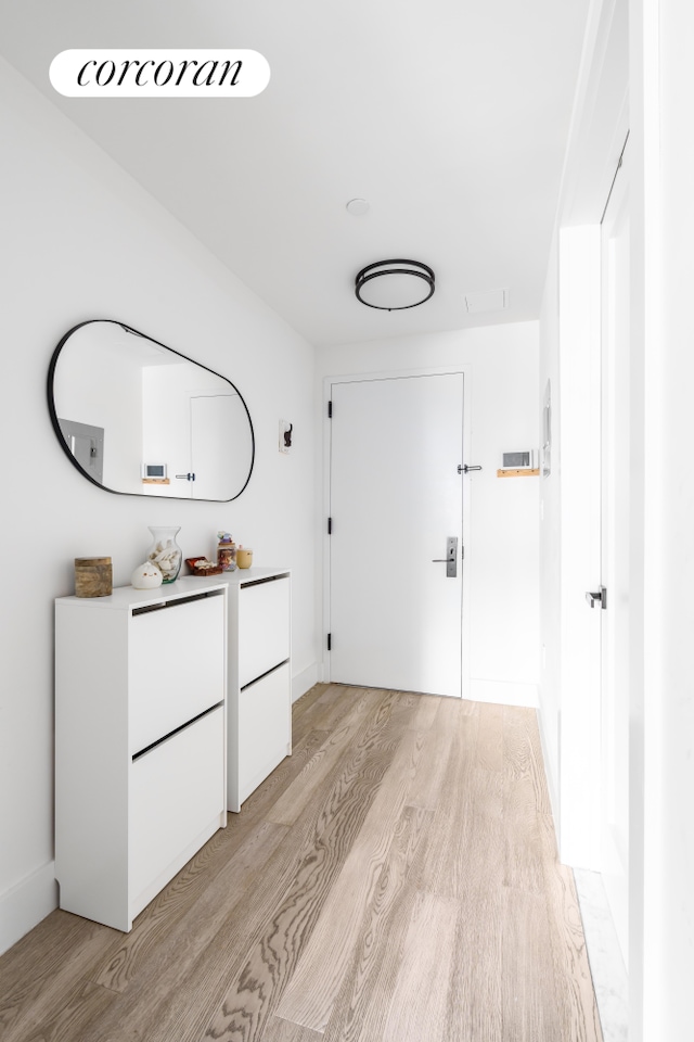 corridor featuring light wood-style flooring