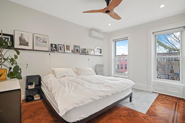 bedroom featuring recessed lighting, baseboards, a wall unit AC, and radiator heating unit