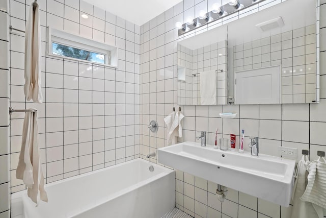 bathroom with a sink, shower / tub combo, decorative backsplash, and tile walls