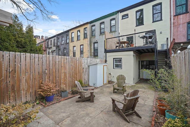 view of patio / terrace with a fenced backyard and stairs