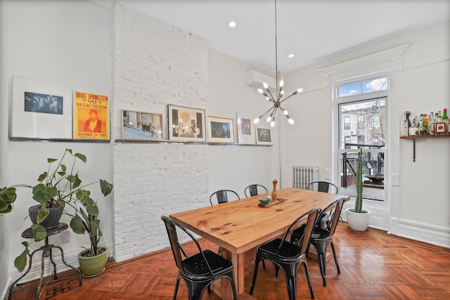 dining area with radiator, brick wall, a chandelier, and recessed lighting