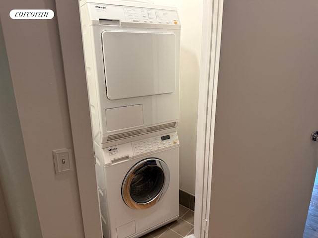 145 Nassau St Unit 8A, New York City, NY 10038 - laundry area featuring stacked washing machine and dryer and tile patterned flooring