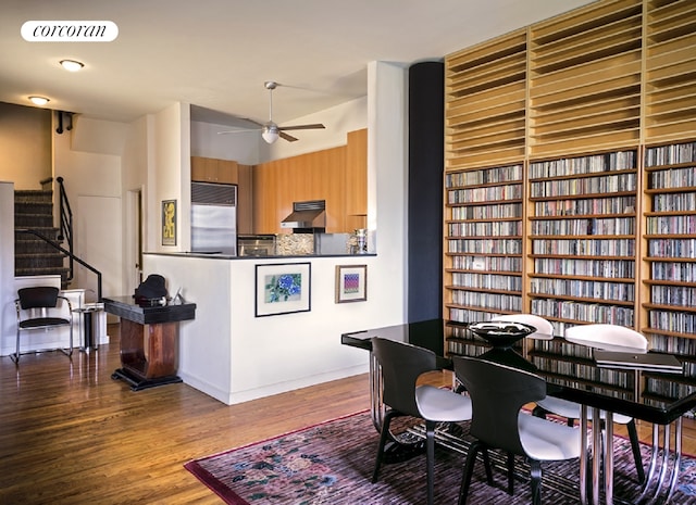 kitchen featuring visible vents, a ceiling fan, wood finished floors, under cabinet range hood, and built in fridge