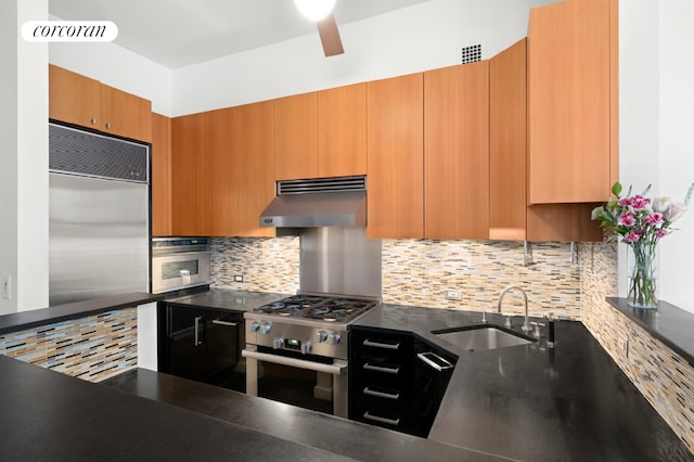 145 Nassau St Unit 8A, New York City, NY 10038 - kitchen with under cabinet range hood, high end appliances, a sink, backsplash, and dark countertops