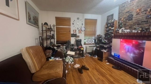 living room with a textured ceiling and wood finished floors