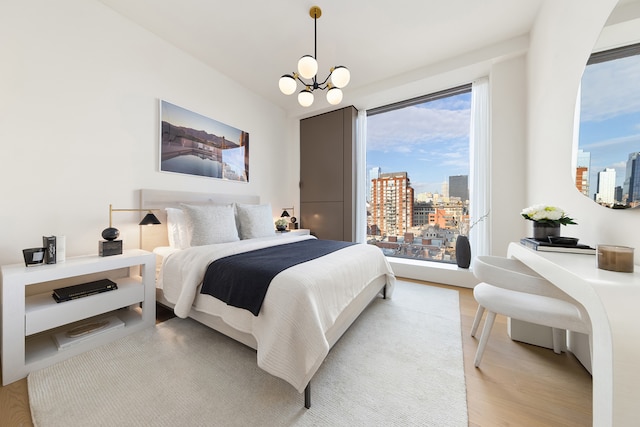 251 W 14th Street Penthouse, New York City, NY 10011 - bedroom with a city view, a chandelier, and light wood-type flooring