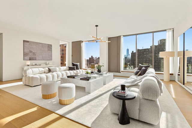 251 W 14th Street Penthouse, New York City, NY 10011 - living area featuring a view of skyline, wood finished floors, and a chandelier