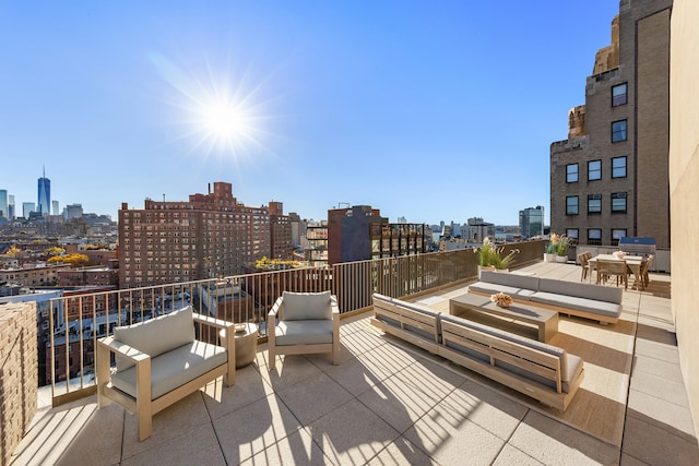 view of patio with a city view, an outdoor living space, a balcony, and grilling area