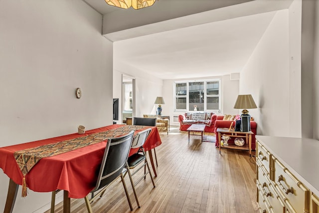 dining space featuring light wood-style flooring