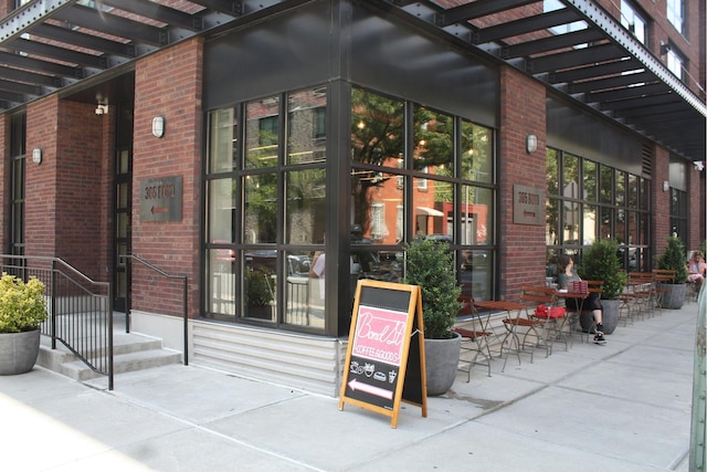 entrance to property featuring brick siding