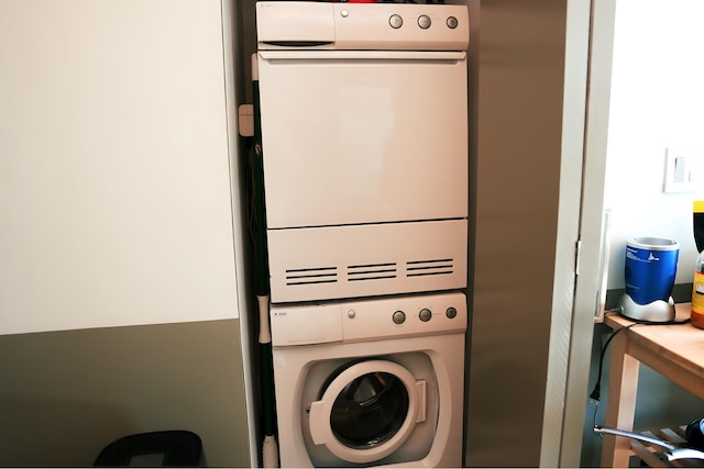 laundry area with laundry area and stacked washer / drying machine