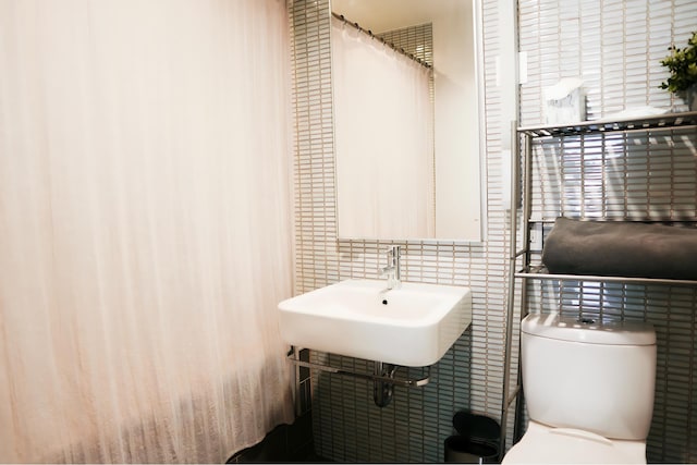 bathroom with toilet and a sink