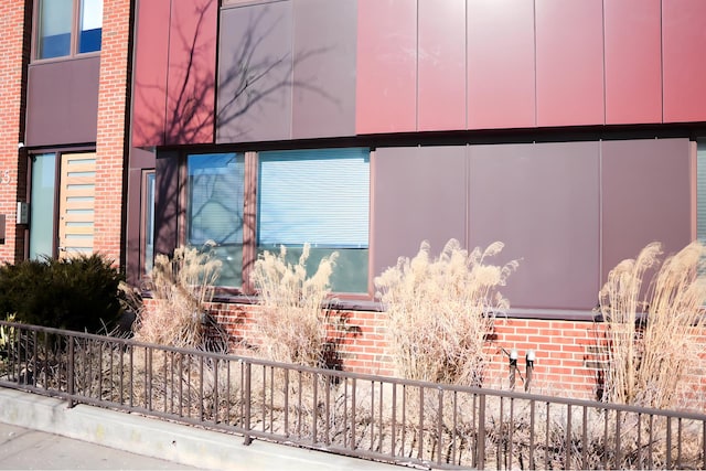 view of side of home featuring brick siding