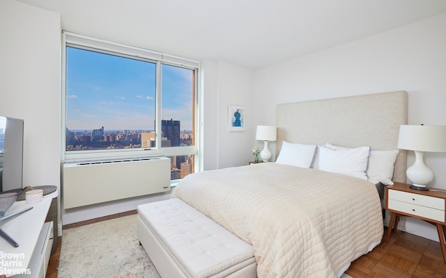 bedroom with radiator heating unit and a city view