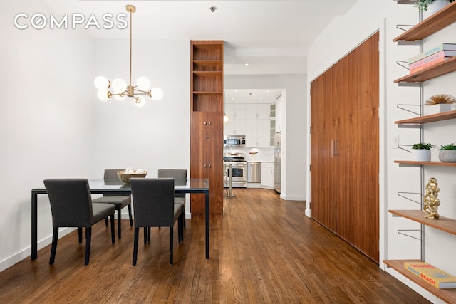 dining area with a chandelier, baseboards, and dark wood finished floors