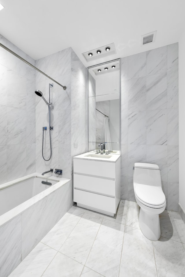 full bath featuring tile walls, bathing tub / shower combination, visible vents, toilet, and vanity