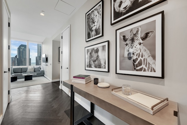 corridor with baseboards and a city view