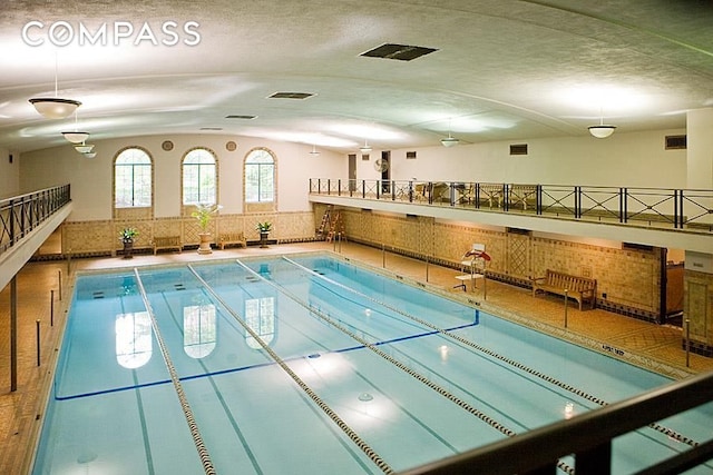 view of sport court with a community pool