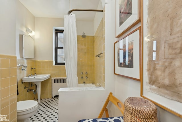 420 E 86th St Unit 4H, New York City, NY 10028 - bathroom with radiator heating unit, tile walls, shower / tub combo, toilet, and a wainscoted wall