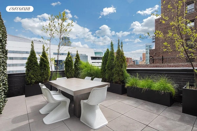 view of patio / terrace with a view of city and outdoor dining area