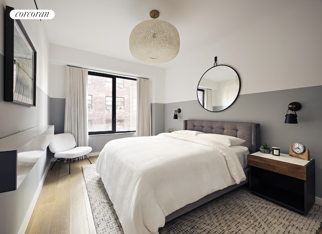 bedroom featuring light wood-type flooring and baseboards