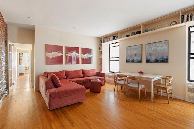 living area featuring radiator and light wood-style flooring