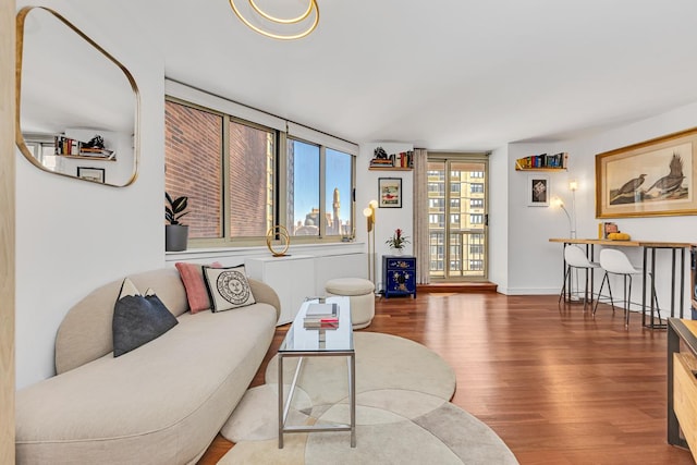 living room with baseboards and wood finished floors