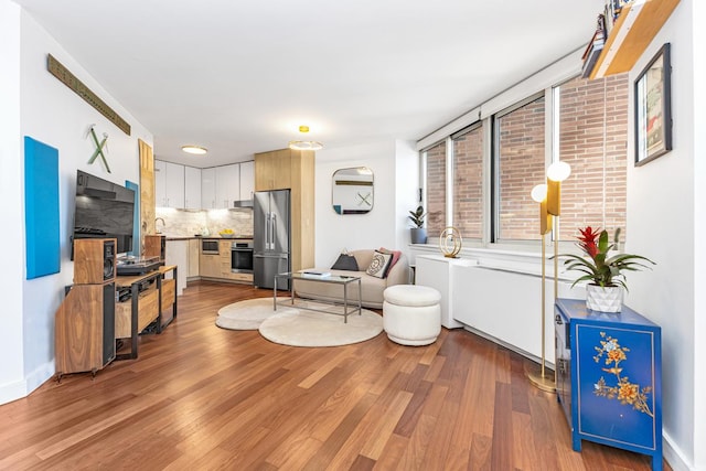 206 E 95th St Unit 7C, New York City, NY 10128 - living area featuring baseboards and wood finished floors