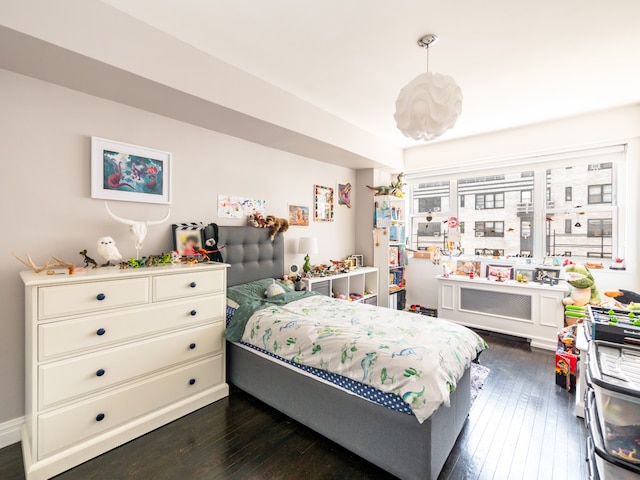 bedroom with dark wood finished floors