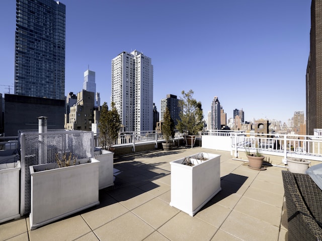 view of patio / terrace with an outdoor fire pit and a view of city