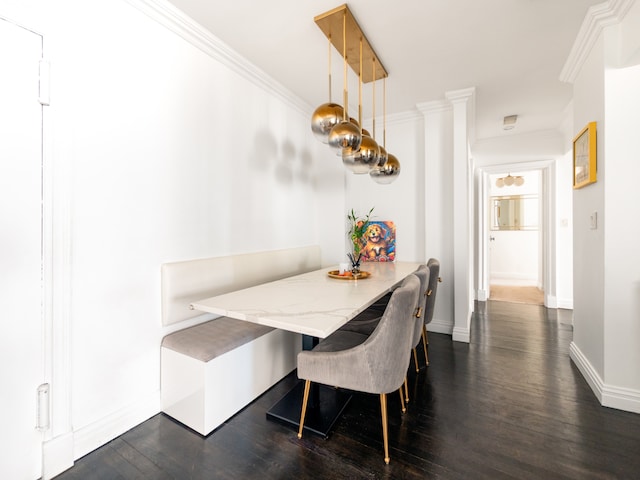 dining area with dark wood finished floors, baseboards, crown molding, and breakfast area