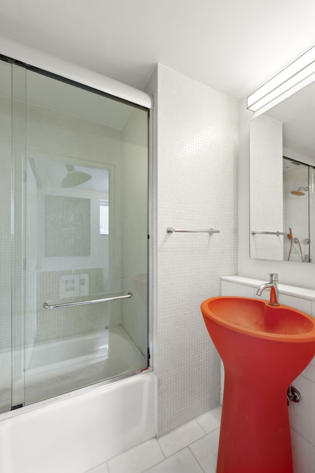 full bathroom featuring combined bath / shower with glass door, tile walls, and tile patterned floors