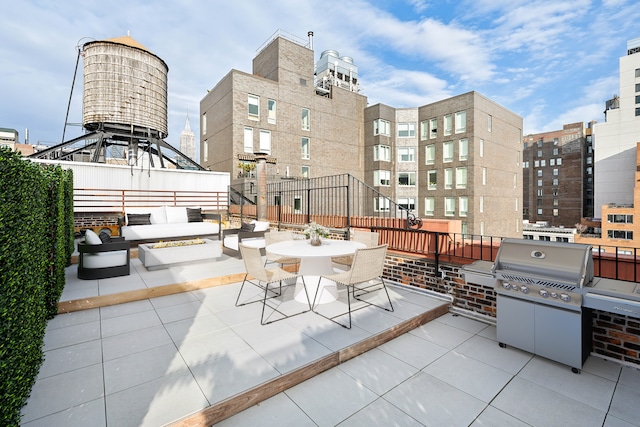 view of patio featuring outdoor dining space, grilling area, and an outdoor living space with a fire pit