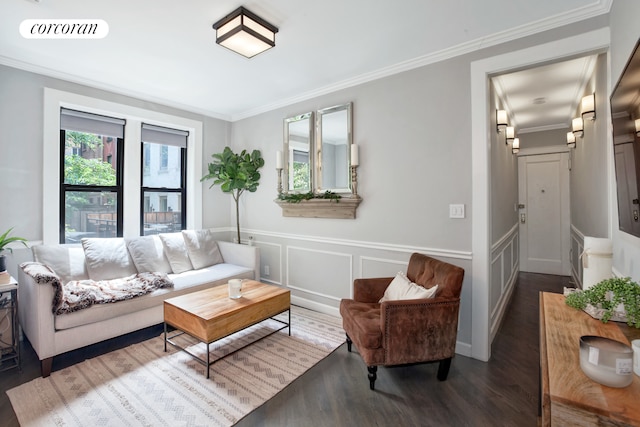 living area featuring visible vents, crown molding, a decorative wall, and wood finished floors