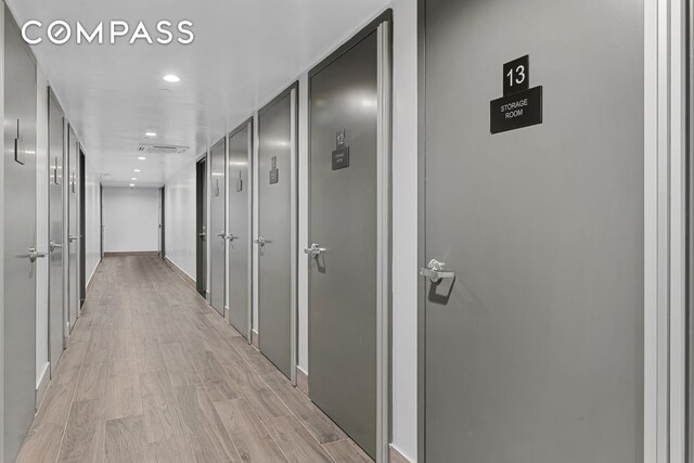 hallway featuring recessed lighting, visible vents, and light wood-style floors