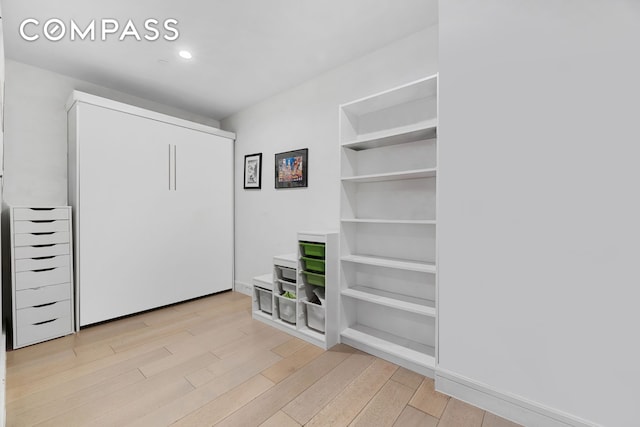 interior space with light wood-style floors, baseboards, and recessed lighting