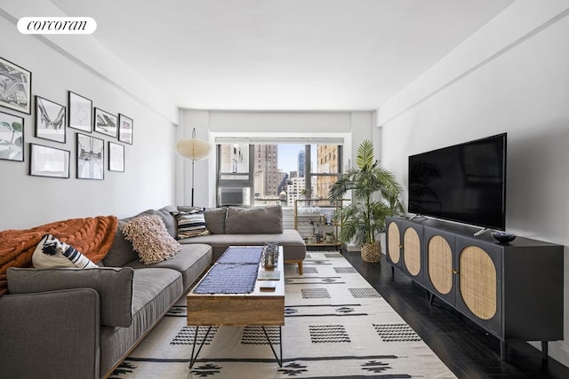 living area with visible vents and wood finished floors