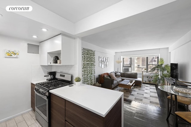 kitchen with visible vents, light countertops, modern cabinets, and stainless steel range with gas stovetop