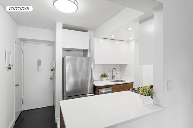 kitchen featuring visible vents, white cabinets, modern cabinets, appliances with stainless steel finishes, and a sink