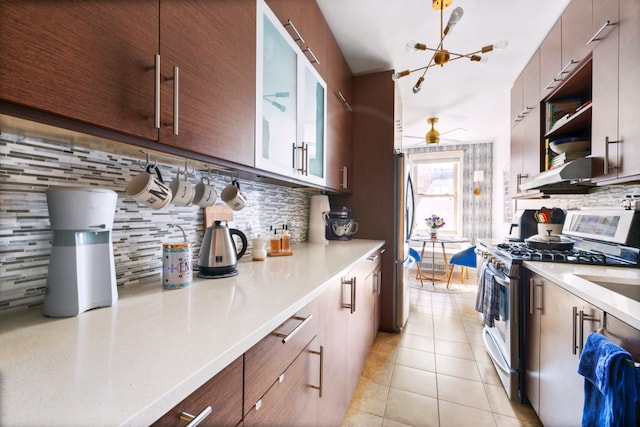 kitchen featuring extractor fan, light tile patterned floors, light countertops, and stainless steel appliances