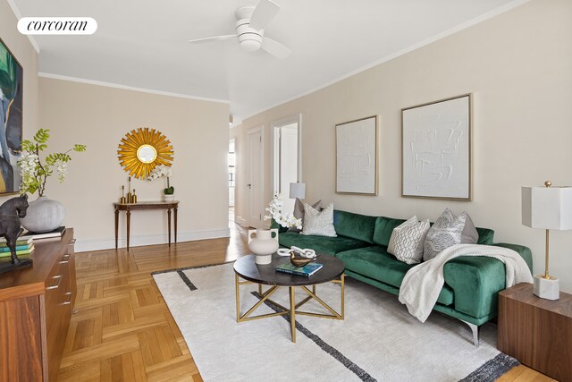 living room featuring baseboards, visible vents, a ceiling fan, and ornamental molding