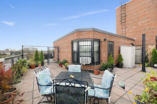 view of patio featuring outdoor dining space, a gate, and fence