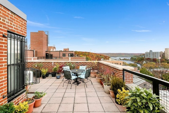 balcony with a water view and a city view