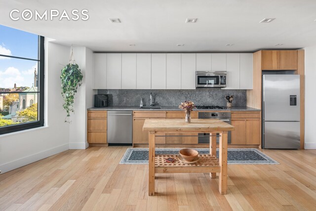 living room with light wood finished floors and baseboards