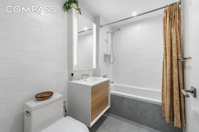 full bathroom featuring tile patterned flooring, tiled shower / bath combo, toilet, and vanity
