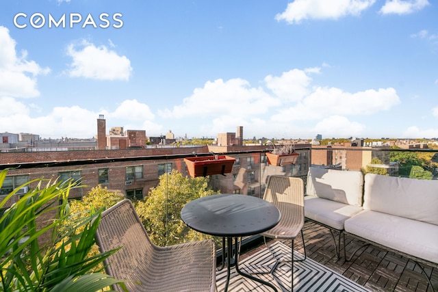 balcony with outdoor lounge area and a city view