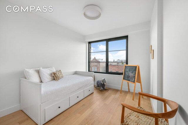 bedroom featuring light wood-style flooring and baseboards