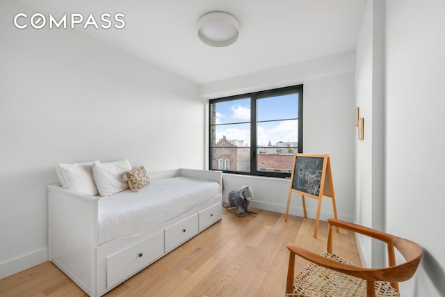 bedroom featuring baseboards and light wood-type flooring